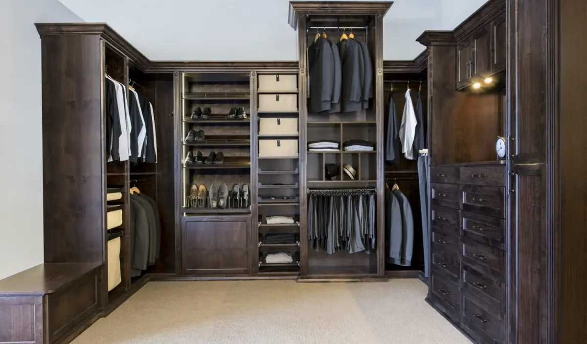 All-wood men’s walk-in closet with dark custom cabinetry in South Bradenton, FL