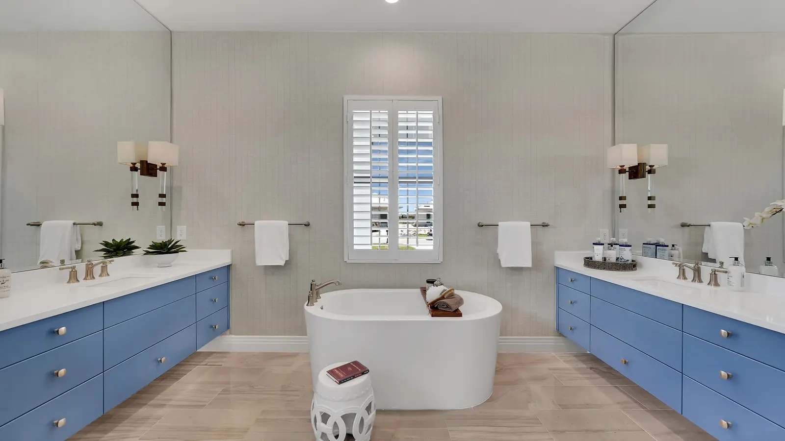 Contemporary bathroom with blue custom double vanities and a freestanding tub in Florida