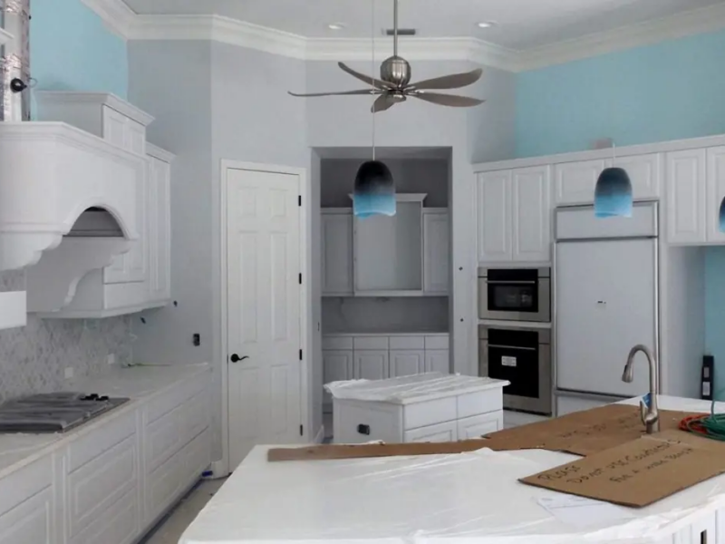 White custom kitchen cabinets during installation