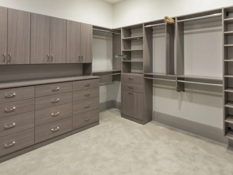 Walk-in closet with gray custom cabinetry and open shelving