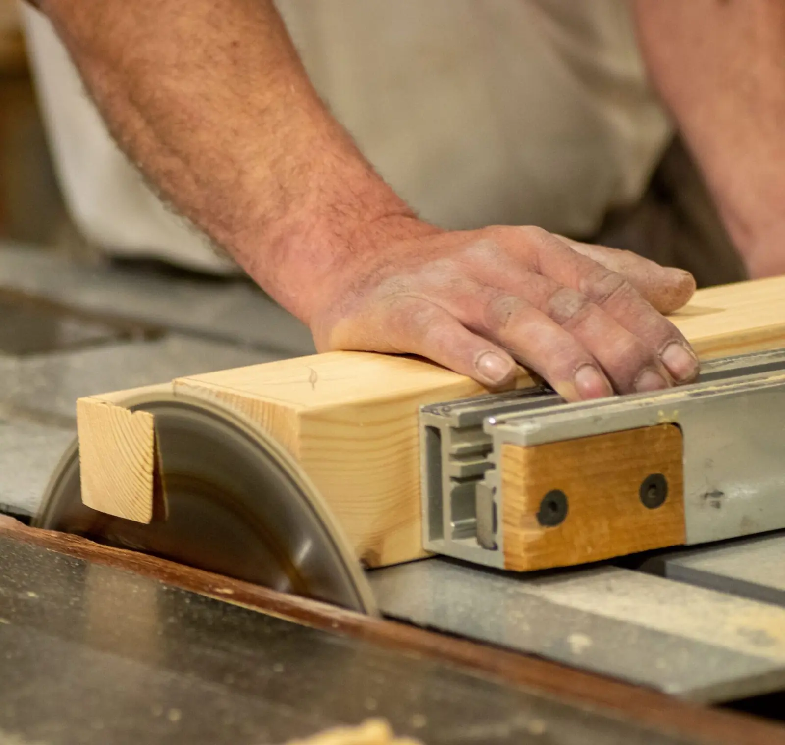 Craftsman cutting cabinet material on a table saw in Florida