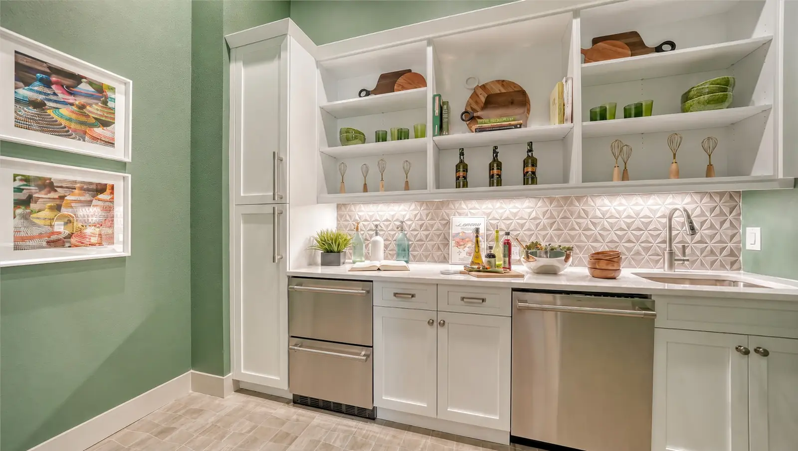 Kitchenette with white custom cabinets, open shelving, and beverage drawers