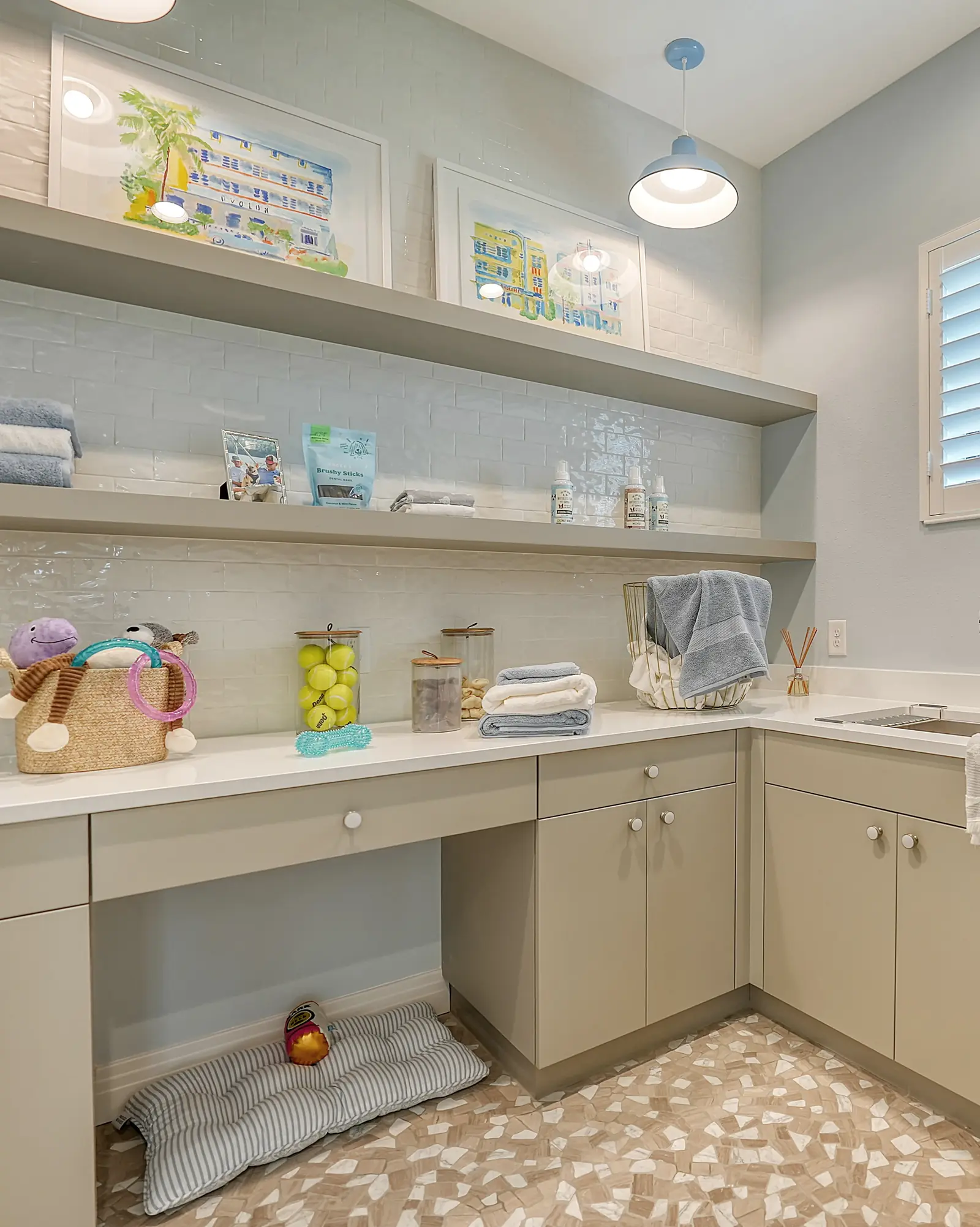 Laundry room with custom base cabinets, a work desk, and floating shelves