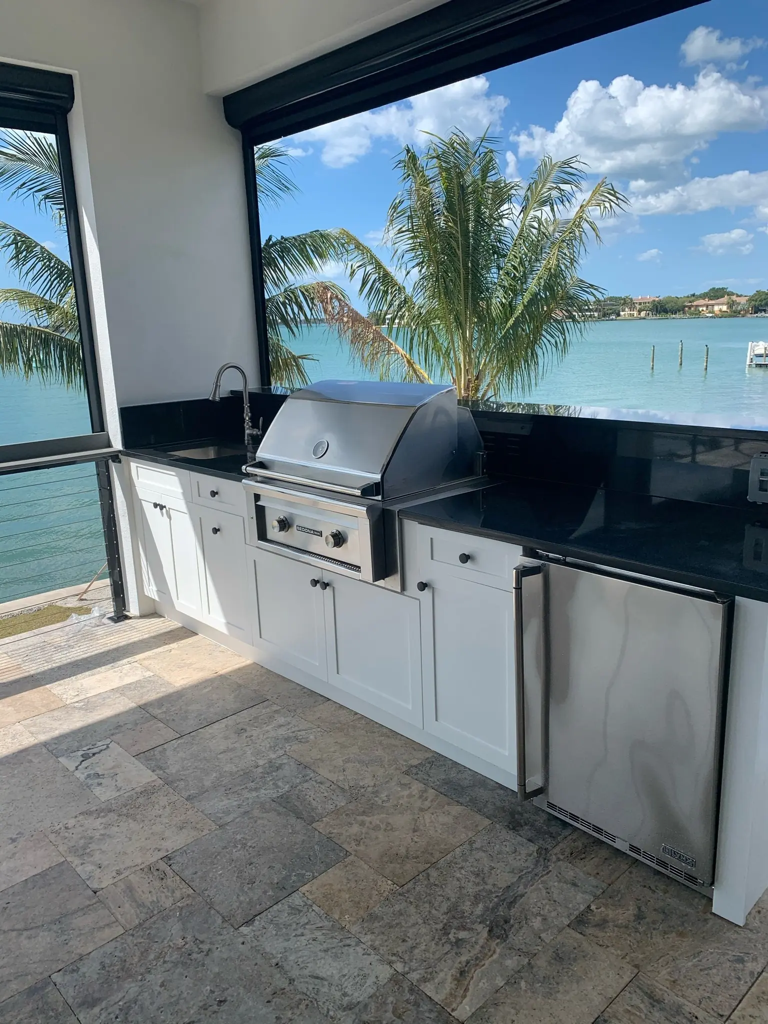 Outdoor kitchen with custom cabinets and a built-in grill