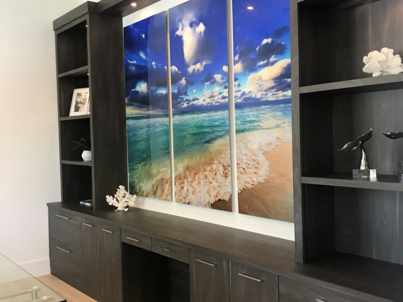 Dark wood built-in media wall with a desk and display shelves