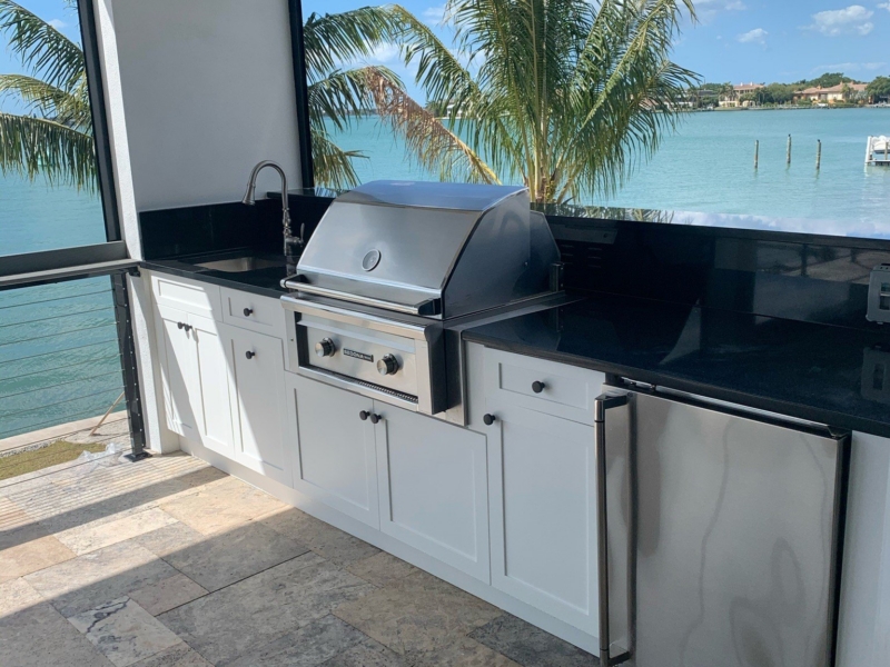 Outdoor kitchen with custom cabinets and a built-in grill