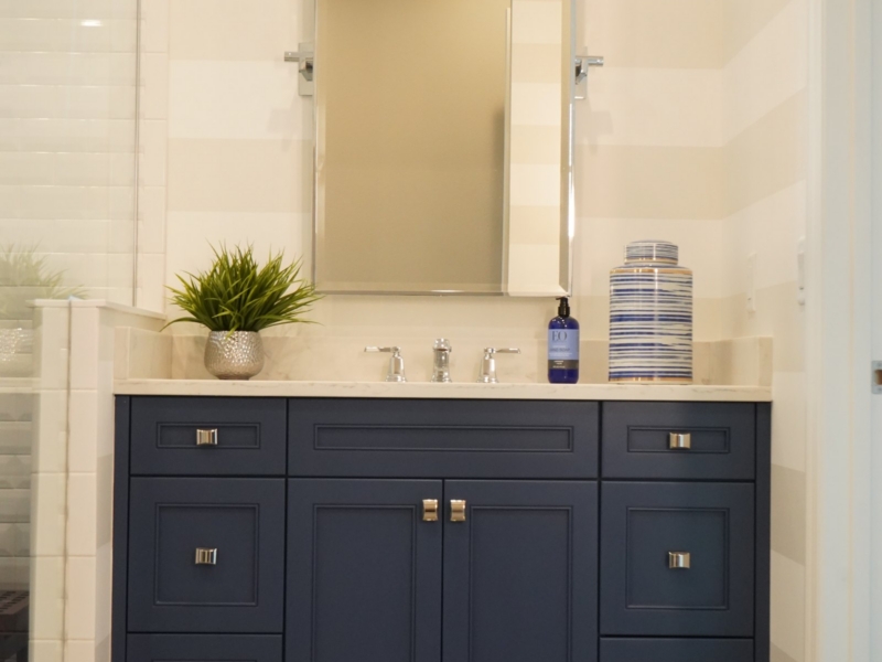 Transitional bathroom with a navy shaker vanity and a tall mirror