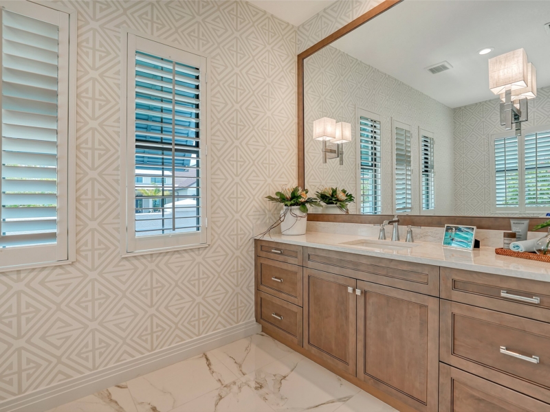 Transitional bathroom with a stained wood double vanity and wood-framed mirror