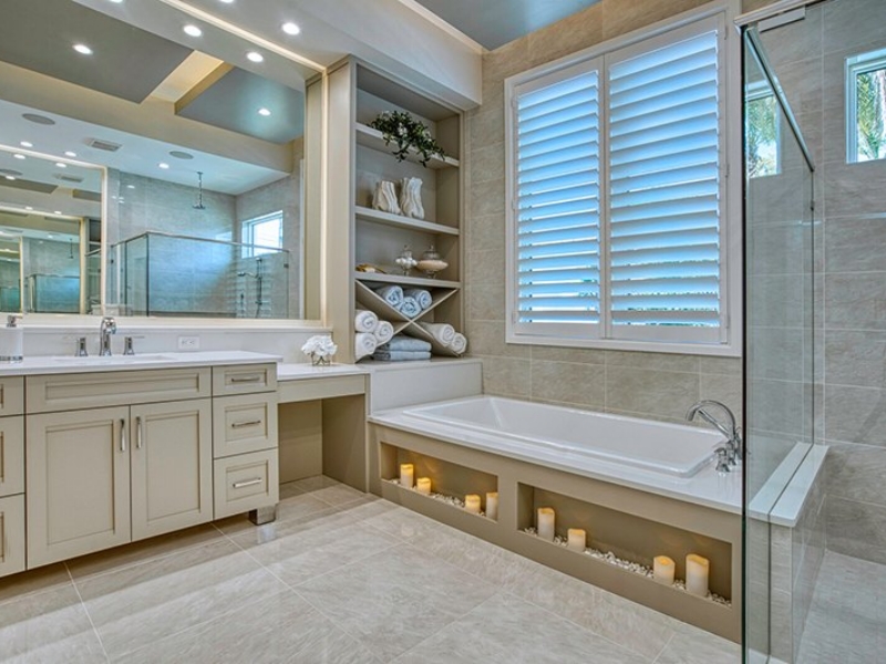 Transitional bathroom with custom vanity cabinets, open shelving, and a soaking tub
