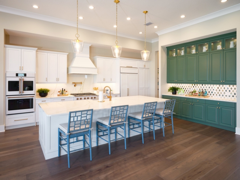 Transitional kitchen with white cabinets, a green hutch, and a large island