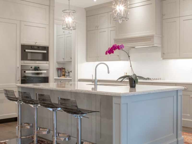 Transitional kitchen with light gray custom cabinets and island seating