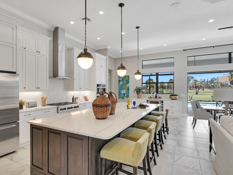 Open-plan transitional kitchen with a stained wood island and white perimeter cabinets