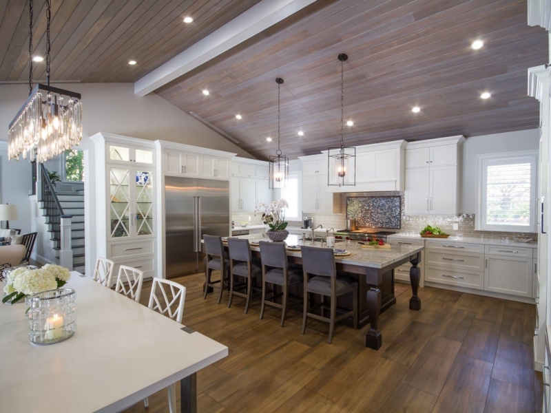 Transitional kitchen with white custom cabinets under a vaulted wood ceiling