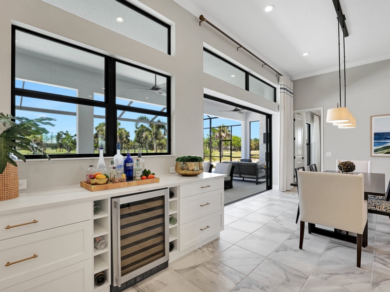 White built-in buffet with a wine refrigerator in a dining area