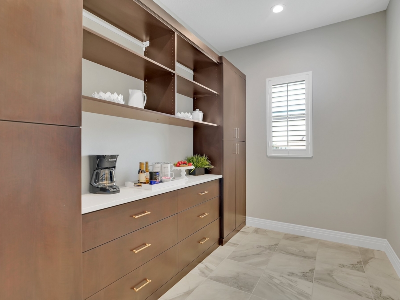Built-in coffee bar with wood cabinets and open shelving