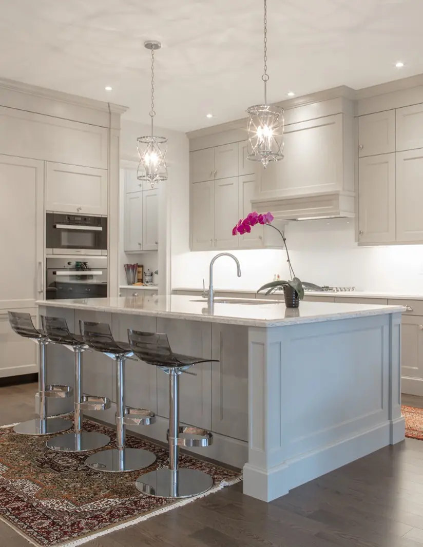 Transitional kitchen with light gray custom cabinets and island seating