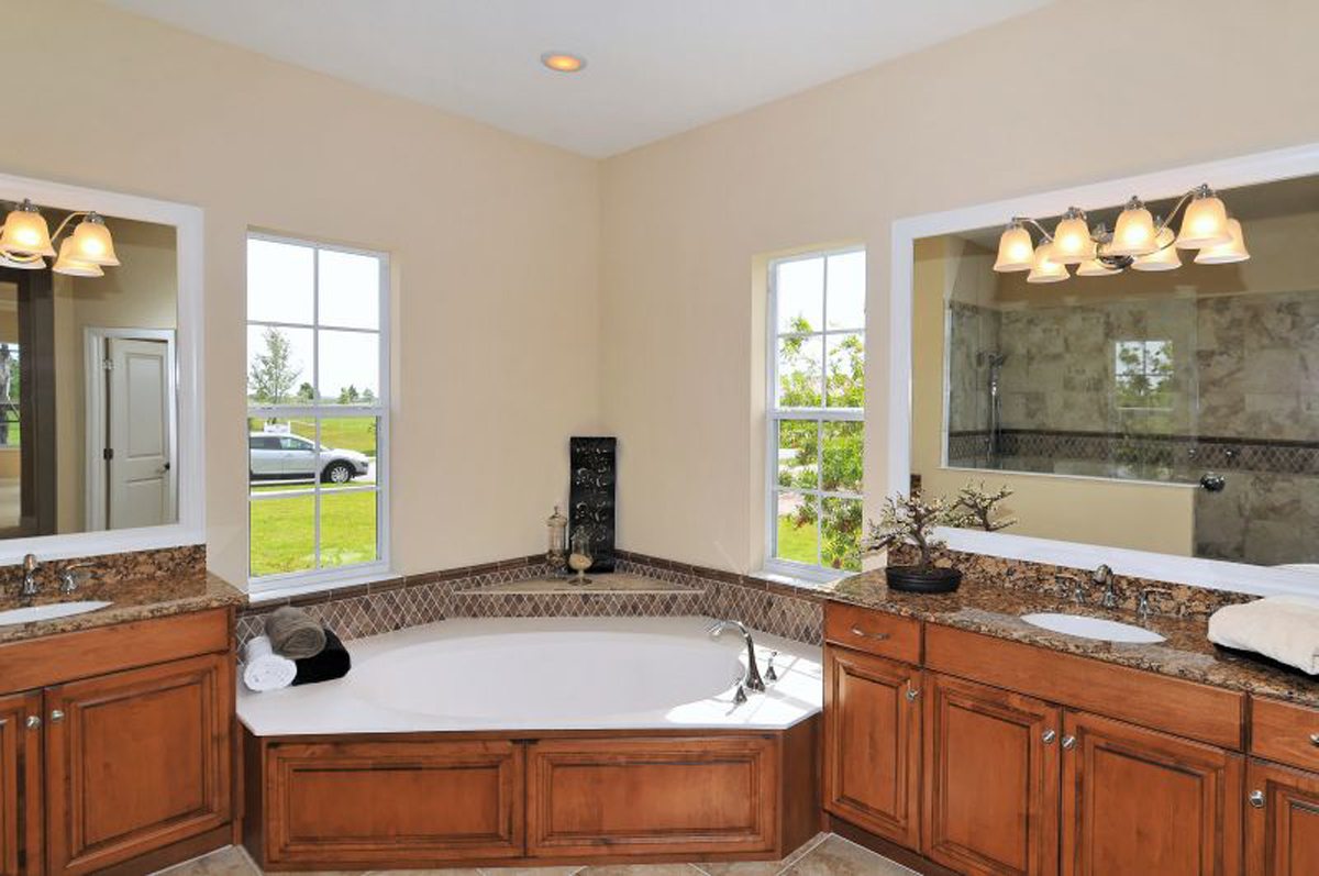 Traditional Bath with Custom Cabinets and Tub Surround